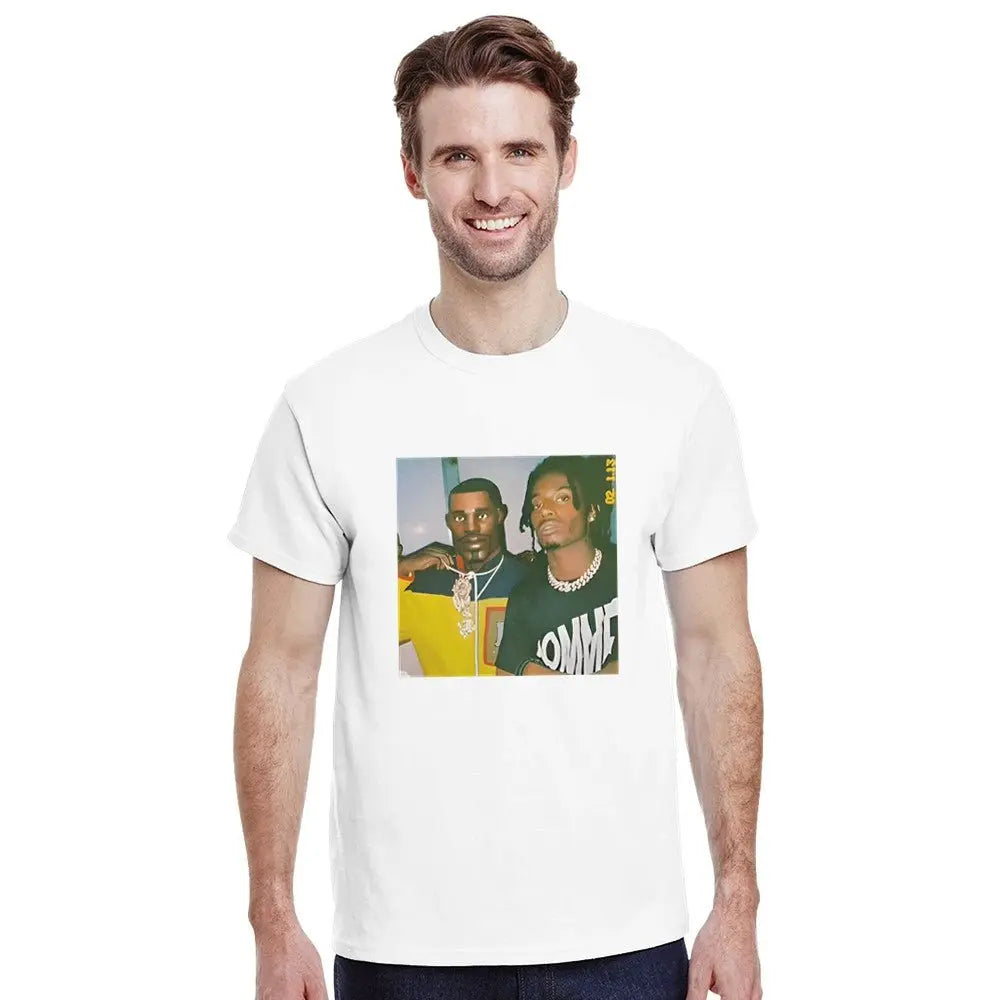 White T-shirt displaying a graphic featuring two hip-hop figures, one in a yellow shirt with a prominent necklace and the other in a black shirt with bold white text. Carti Perc Battle Royale Shirt. The image has a retro, meme-inspired aesthetic, resonating with fans of hip-hop culture and playful streetwear fashion.