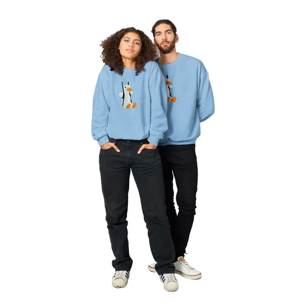 A man and woman in cozy blue sweatshirts featuring a playful penguin graphic, perfect for at home or playful casual wear.