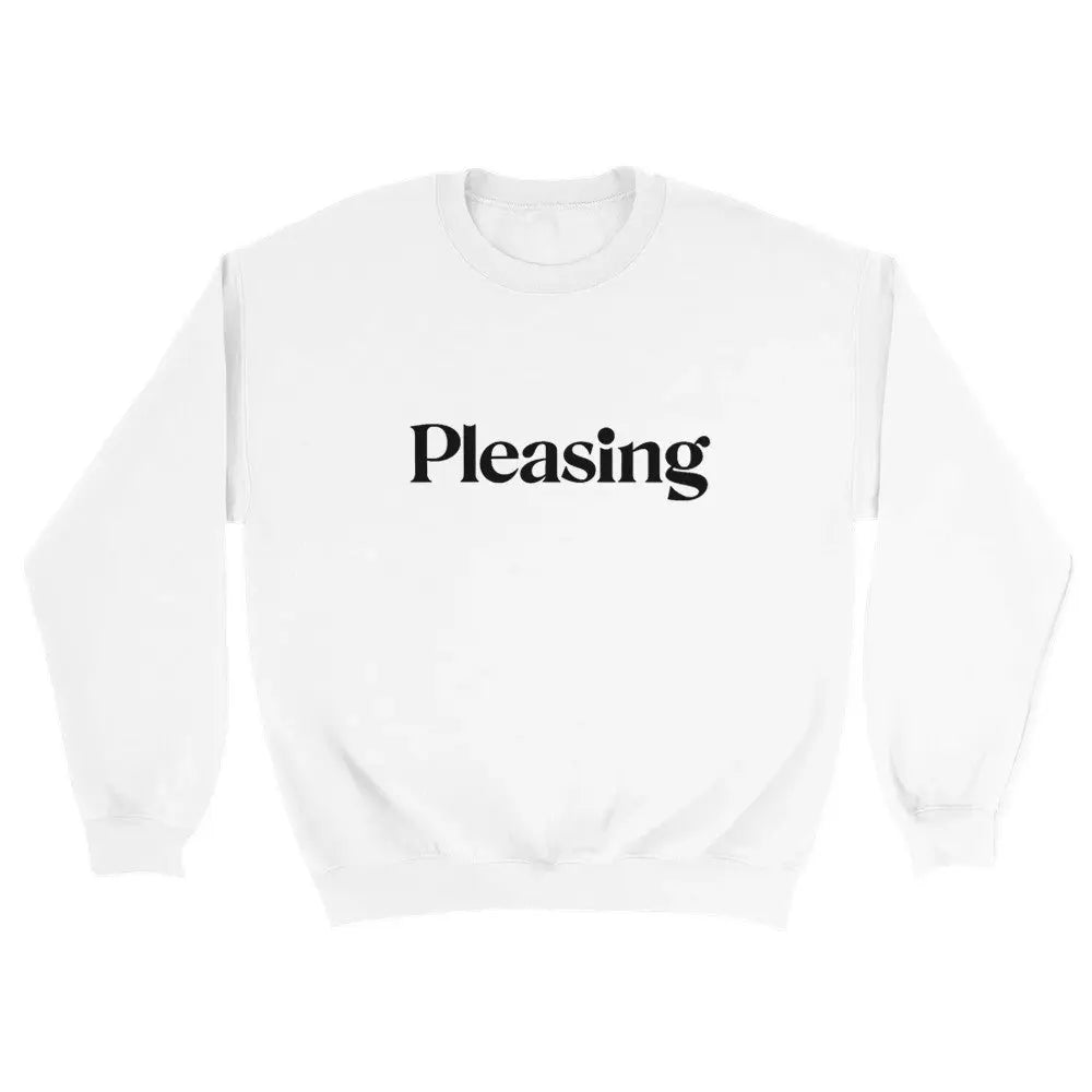 White sweatshirt featuring the word "Pleasing" in a stylish, serif font across the chest. The minimalist design references the branding associated with Harry Styles, appealing to fans of his aesthetic and brand. The overall look is simple yet trendy.