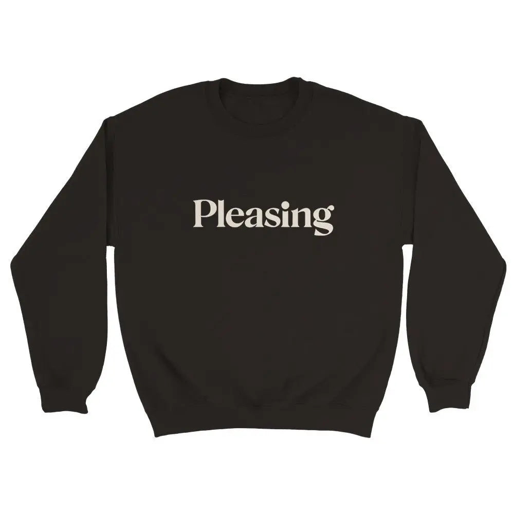 Black sweatshirt featuring the word "Pleasing" in a stylish, serif font across the chest. The minimalist design references the branding associated with Harry Styles, appealing to fans of his aesthetic and brand. The overall look is simple yet trendy.