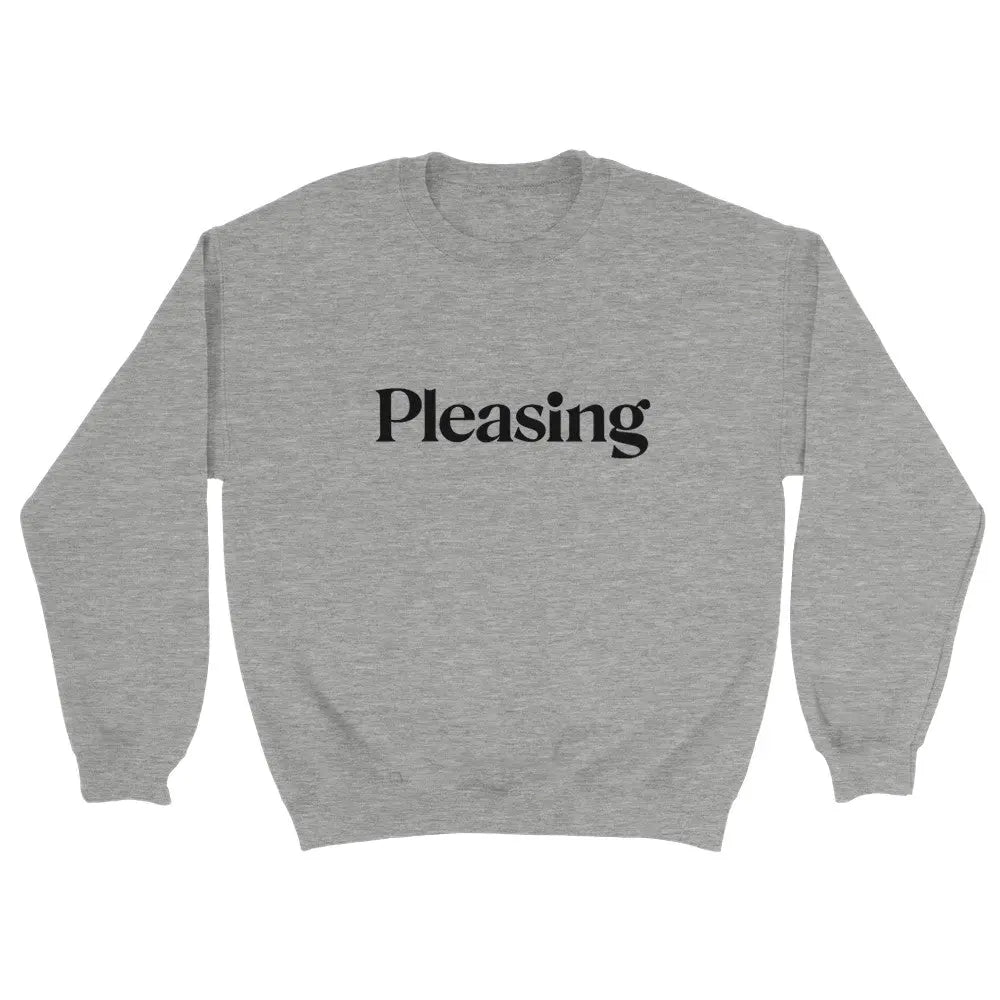 Grey sweatshirt featuring the word "Pleasing" in a stylish, serif font across the chest. The minimalist design references the branding associated with Harry Styles, appealing to fans of his aesthetic and brand. The overall look is simple yet trendy.