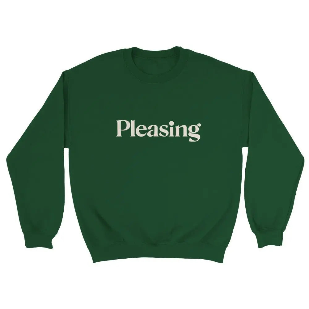 Green sweatshirt featuring the word "Pleasing" in a stylish, serif font across the chest. The minimalist design references the branding associated with Harry Styles, appealing to fans of his aesthetic and brand. The overall look is simple yet trendy.