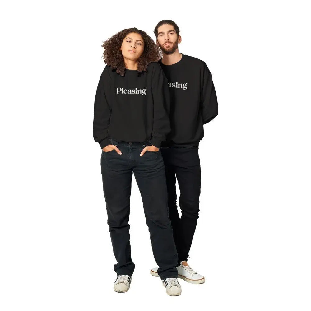 Black sweatshirt featuring the word "Pleasing" in a stylish, serif font across the chest. The minimalist design references the branding associated with Harry Styles, appealing to fans of his aesthetic and brand. The overall look is simple yet trendy.